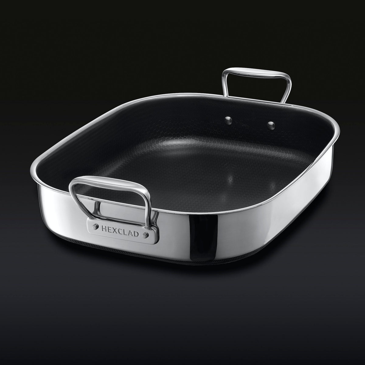 The HexClad Hybrid Roasting Pan on a black backround, shown from a diagonal viewpoint.